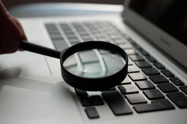 magnifying glass over a laptop