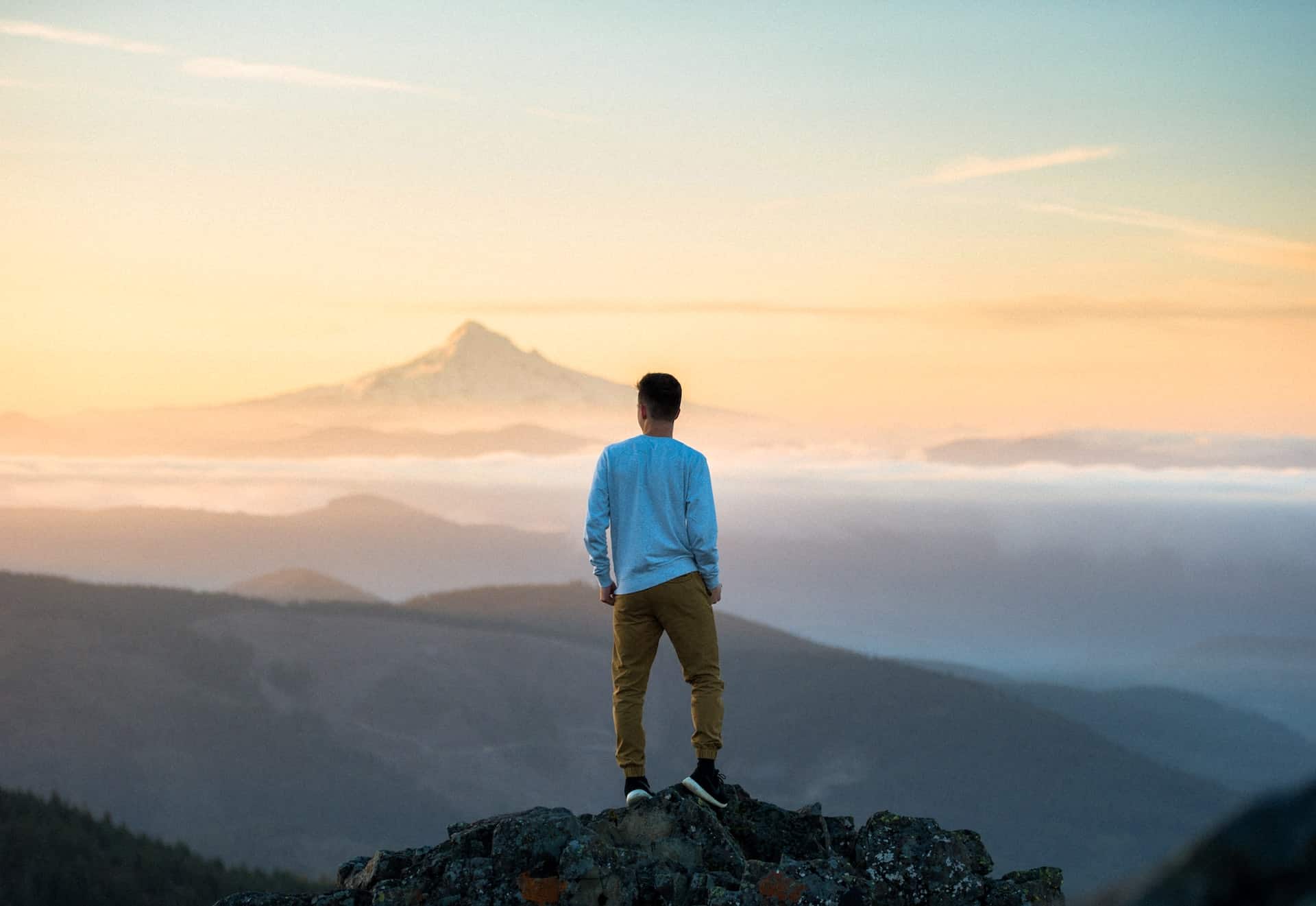 man atop a mountain