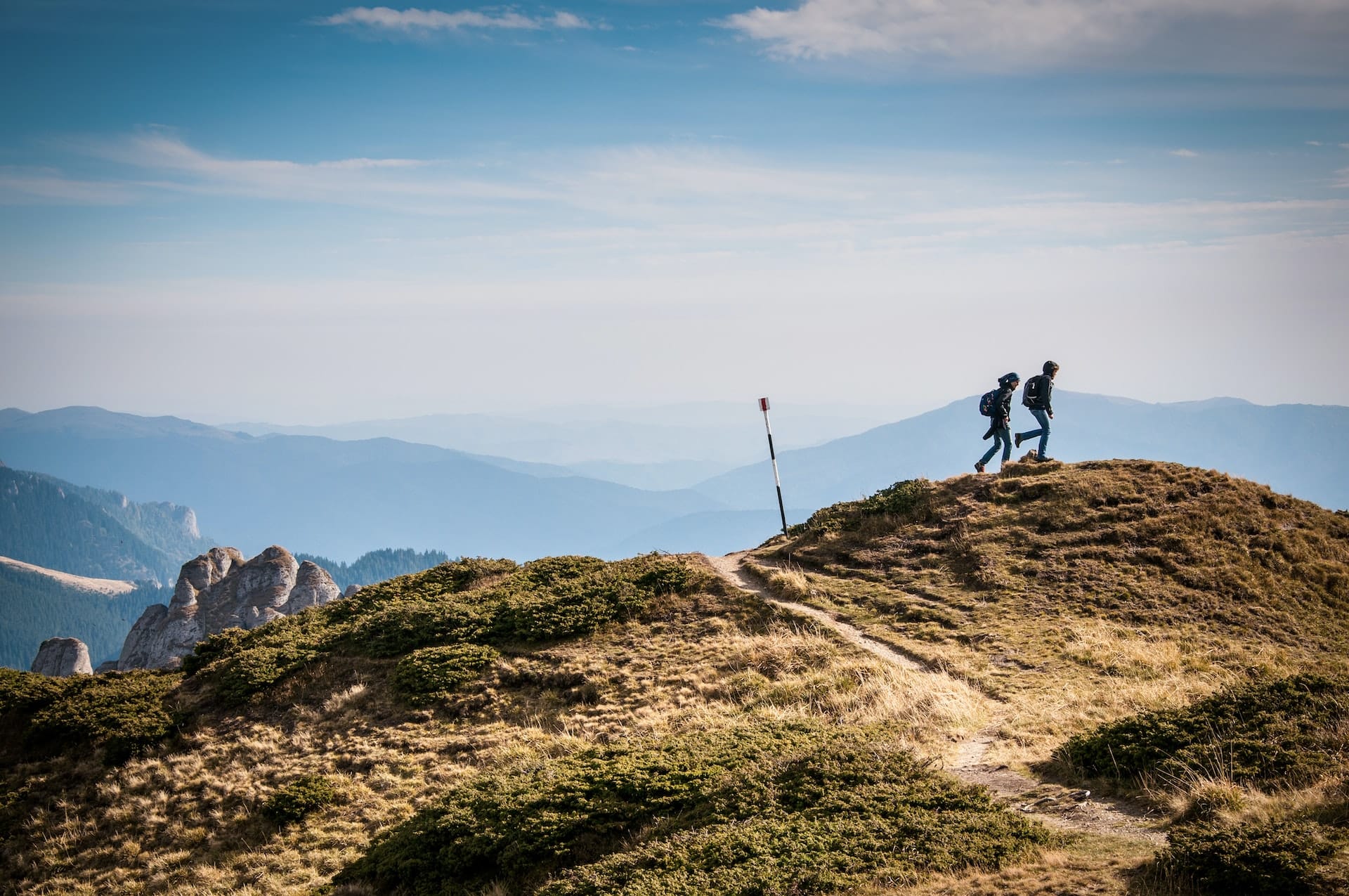 two people hiking a mountain together